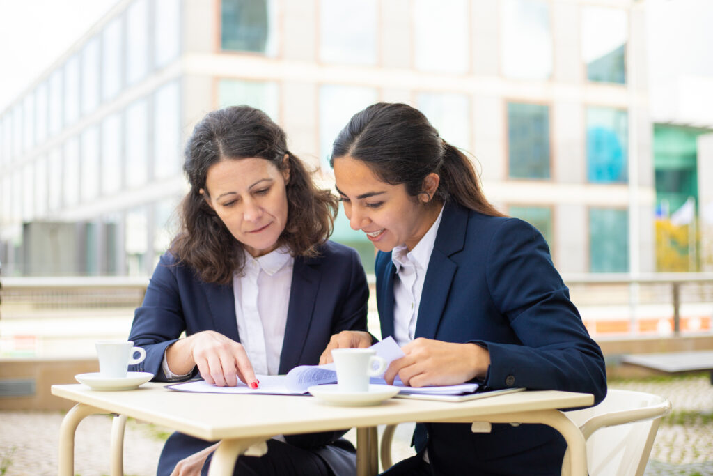 Two ladies are Discussing Official things